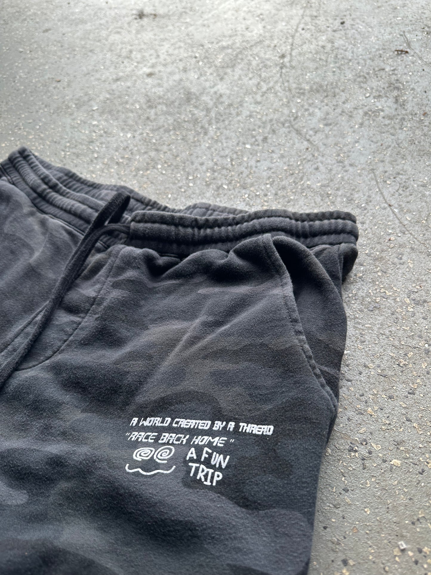 black camo sweatpants bottoms, front pocket, graphic close up